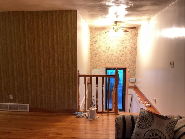 interior space with visible vents, ceiling fan, and wood finished floors