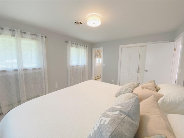 2248 Seneca Dr, Charleston, IL 61920 - bedroom featuring a closet and a baseboard heating unit