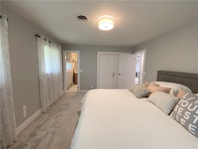 2248 Seneca Dr, Charleston, IL 61920 - bedroom with light carpet, a closet, connected bathroom, and baseboard heating