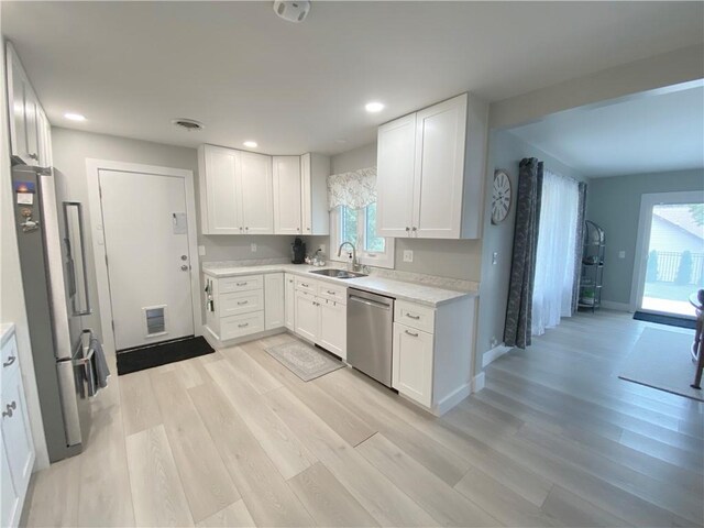 2248 Seneca Dr, Charleston, IL 61920 - kitchen with appliances with stainless steel finishes, light wood-type flooring, light countertops, white cabinetry, and recessed lighting