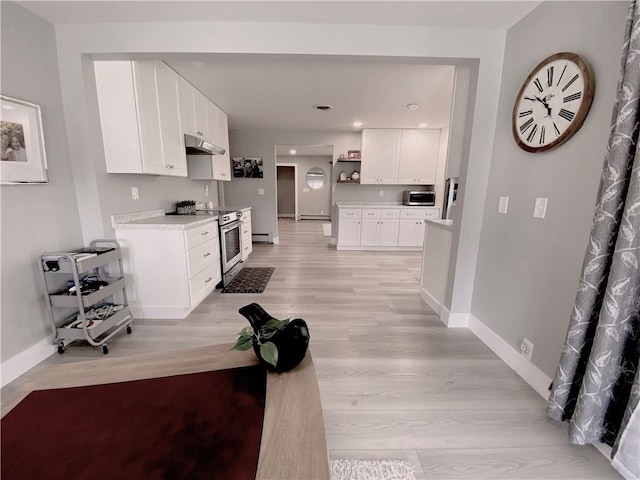 2248 Seneca Dr, Charleston, IL 61920 - kitchen with stainless steel appliances, under cabinet range hood, light countertops, white cabinets, and light wood-style flooring