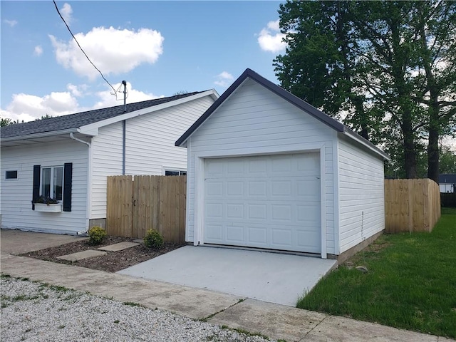 202 S 4th St, Marshall, IL 62441 - view of side of home with an outdoor structure, a detached garage, and concrete driveway