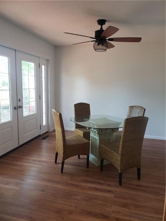 202 S 4th St, Marshall, IL 62441 - dining space featuring french doors, wood finished floors, ceiling fan, and a textured ceiling