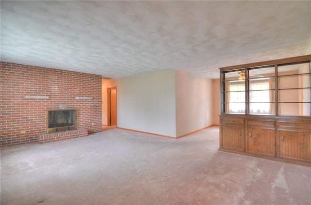 16 Diane Rd, Decatur, IL 62526 - unfurnished living room featuring baseboards, a brick fireplace, a textured ceiling, and carpet floors