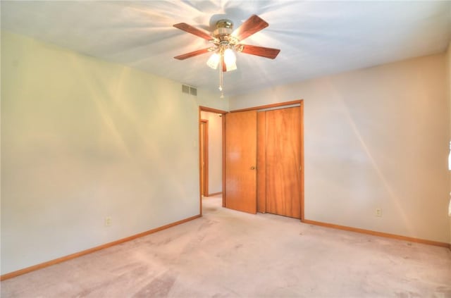 16 Diane Rd, Decatur, IL 62526 - unfurnished bedroom with baseboards, light colored carpet, a closet, and a ceiling fan