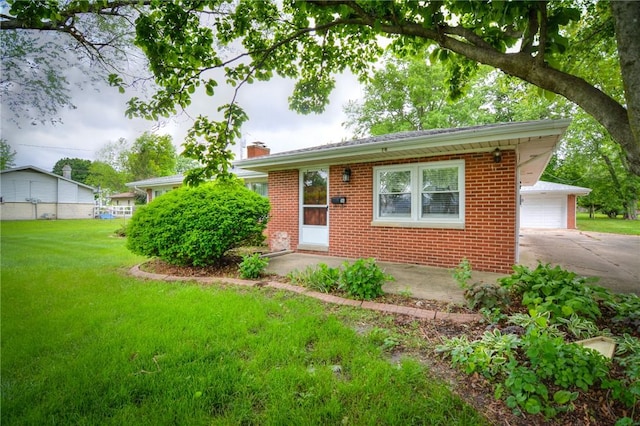 16 Diane Rd, Decatur, IL 62526 - view of front of home with brick siding, a front lawn, a chimney, and a garage