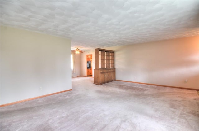 16 Diane Rd, Decatur, IL 62526 - spare room featuring baseboards, light carpet, ceiling fan, and a textured ceiling