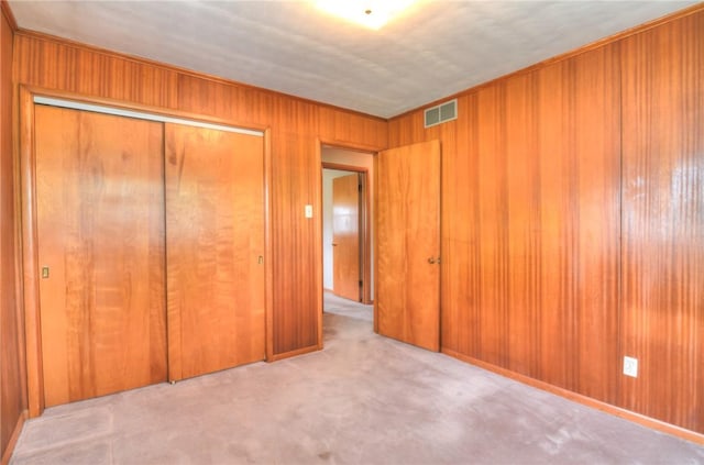 16 Diane Rd, Decatur, IL 62526 - unfurnished bedroom with a closet, wooden walls, and carpet flooring