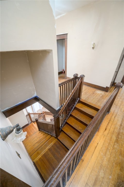 stairs with hardwood / wood-style flooring