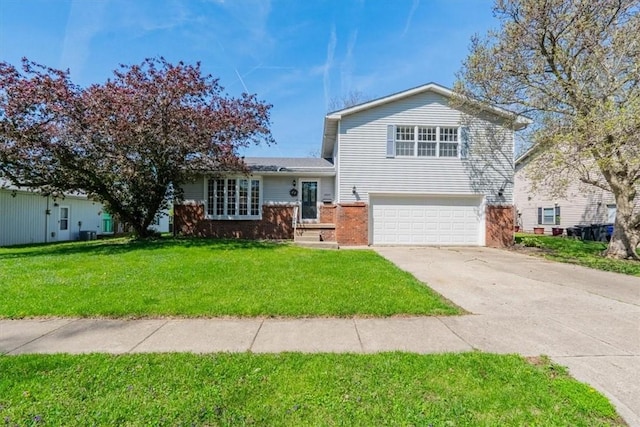 tri-level home featuring brick siding, an attached garage, a front yard, and driveway