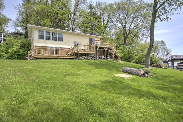 back of house featuring a lawn, stairway, and a deck