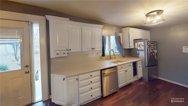 kitchen with dark wood-type flooring, white cabinetry, sink, and stainless steel appliances