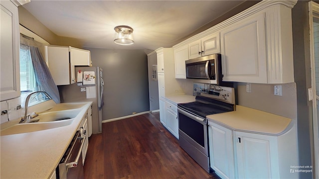 kitchen with dark hardwood / wood-style flooring, white cabinetry, sink, and appliances with stainless steel finishes