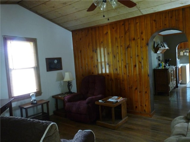 1402 Dean St, Danville, IL 61832 - living room featuring vaulted ceiling, wood finished floors, a ceiling fan, arched walkways, and wood walls