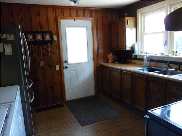 1402 Dean St, Danville, IL 61832 - kitchen featuring a sink, plenty of natural light, freestanding refrigerator, dark wood-type flooring, and wooden walls
