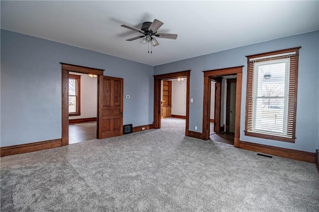 spare room with carpet floors and ceiling fan