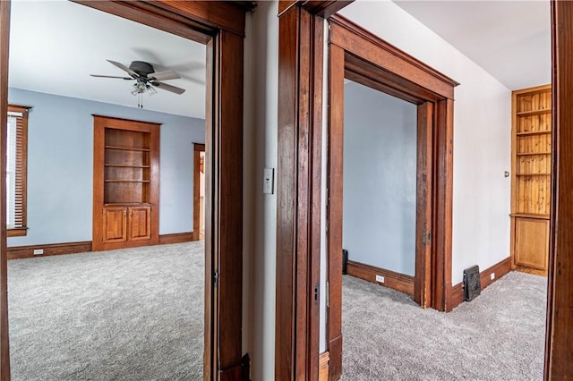 hallway featuring built in features and light carpet