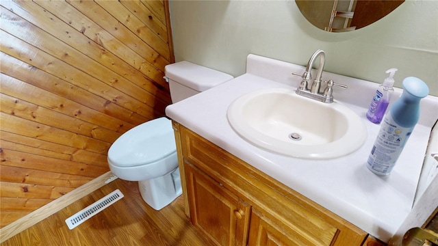 bathroom with visible vents, toilet, wood finished floors, and vanity