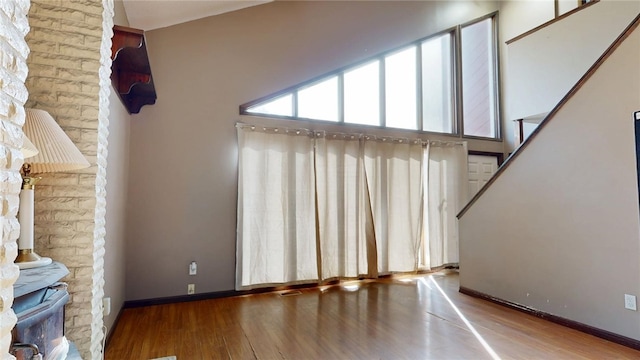 unfurnished living room with baseboards and wood finished floors