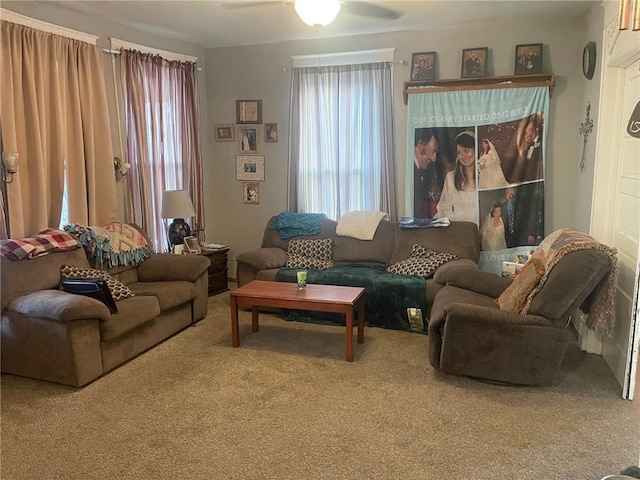 living room featuring ceiling fan and carpet