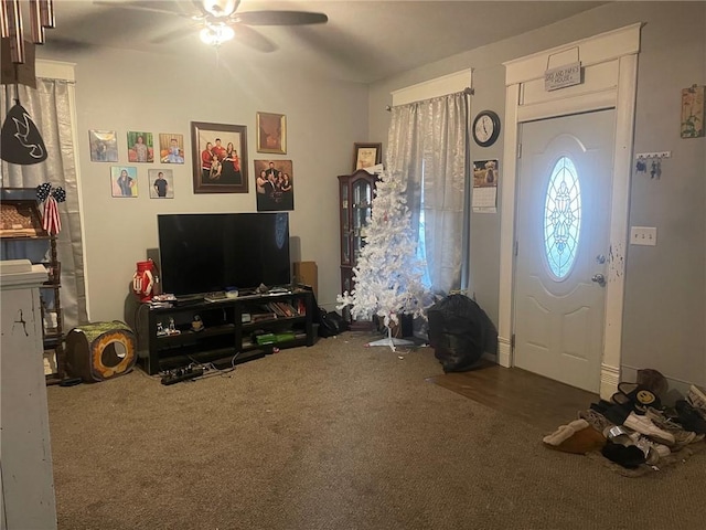 carpeted entrance foyer with ceiling fan