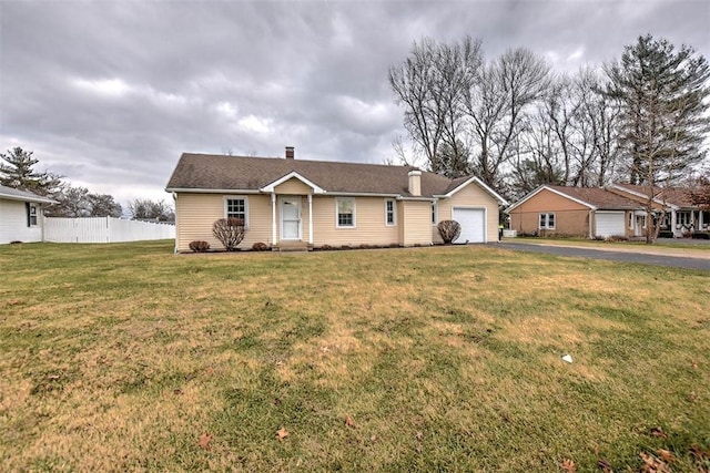 ranch-style house featuring a garage and a front yard