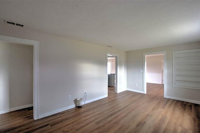 spare room with hardwood / wood-style floors