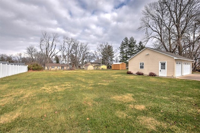 view of yard with a garage and a shed