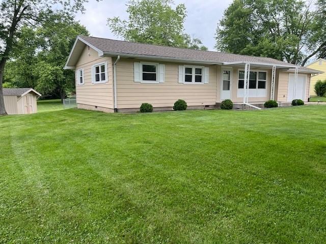 7 Mcdonald Ave, Forsyth, IL 62535 - ranch-style home featuring a front lawn, a storage unit, crawl space, and an attached garage