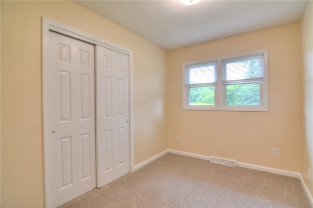 7 Mcdonald Ave, Forsyth, IL 62535 - unfurnished bedroom featuring light carpet and a closet