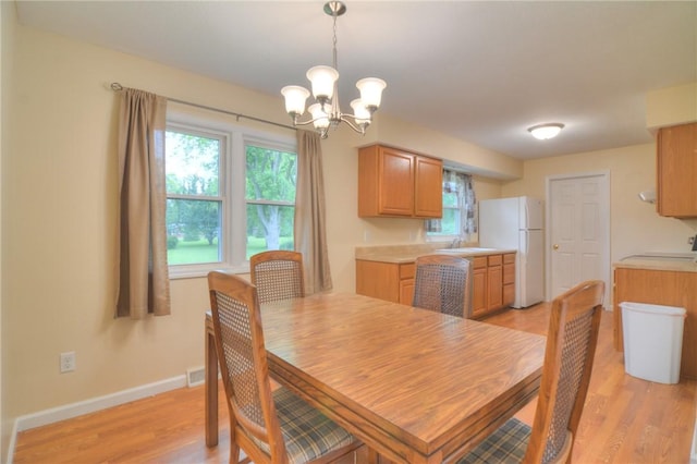 7 Mcdonald Ave, Forsyth, IL 62535 - dining area featuring a chandelier, healthy amount of natural light, and light wood-style flooring