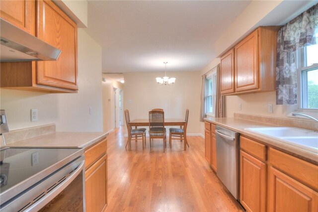 7 Mcdonald Ave, Forsyth, IL 62535 - kitchen with appliances with stainless steel finishes, under cabinet range hood, a chandelier, light wood finished floors, and light countertops
