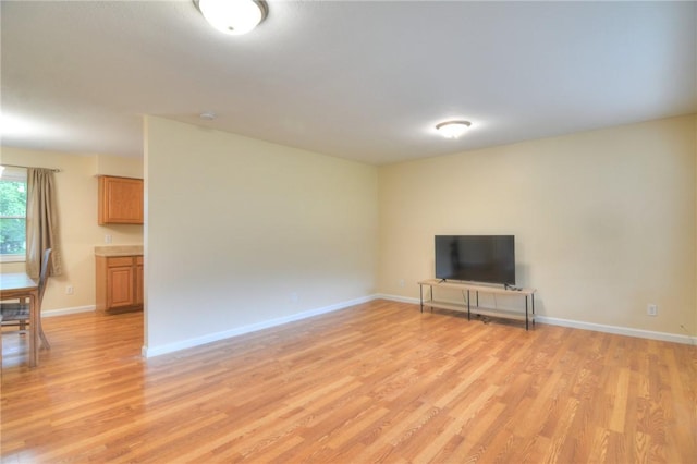 7 Mcdonald Ave, Forsyth, IL 62535 - unfurnished living room featuring light wood-style floors and baseboards