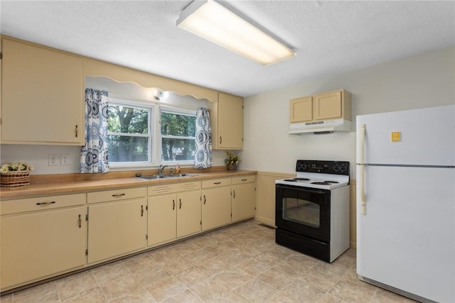 911 Saint Anthony Ave, Effingham, IL 62401 - kitchen with freestanding refrigerator, range with electric cooktop, under cabinet range hood, cream cabinetry, and a textured ceiling