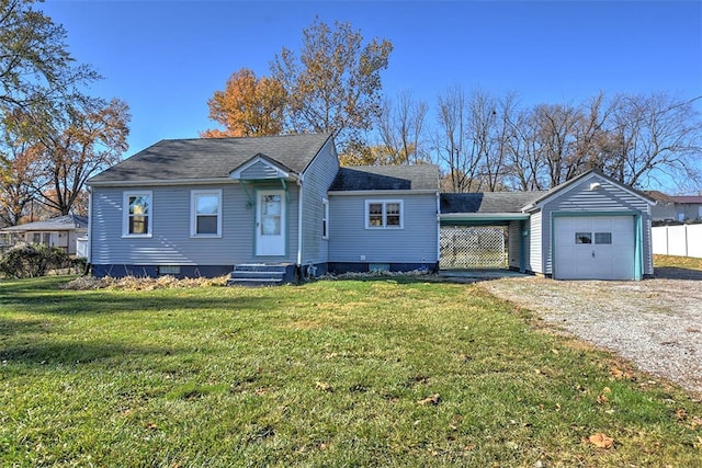 view of front of property featuring a front yard, a garage, and a carport