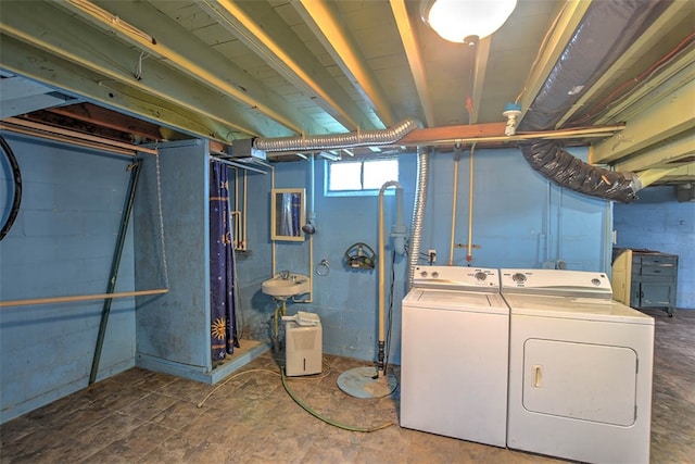 laundry room with washer and clothes dryer and sink