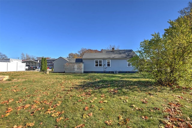 back of property with a yard and a carport