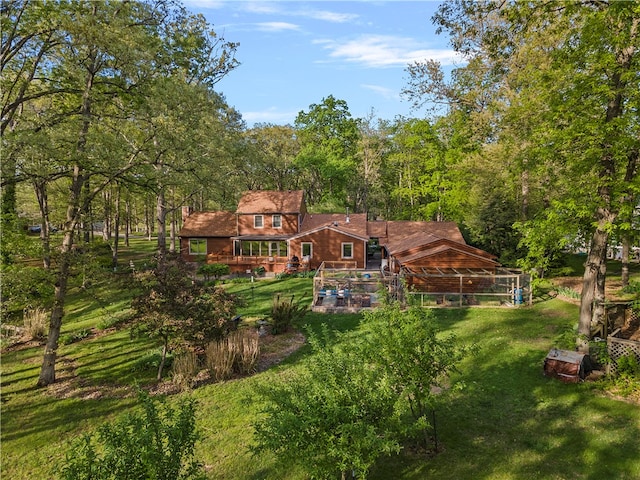 rear view of house featuring a yard