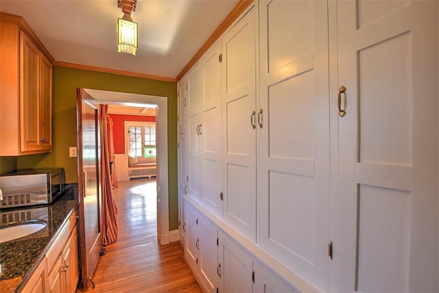 580 Powers Ln, Decatur, IL 62522 - hallway featuring light wood finished floors, a sink, baseboards, and ornamental molding