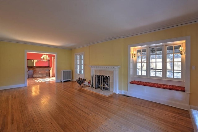 580 Powers Ln, Decatur, IL 62522 - unfurnished living room with wood finished floors, a fireplace, baseboards, radiator, and ornamental molding