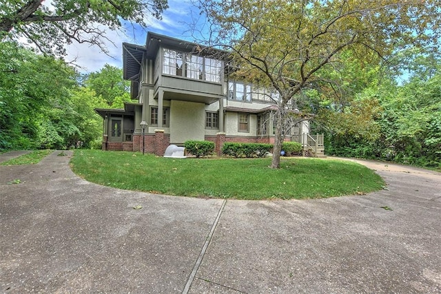 580 Powers Ln, Decatur, IL 62522 - view of front of house with stucco siding, a front lawn, and brick siding