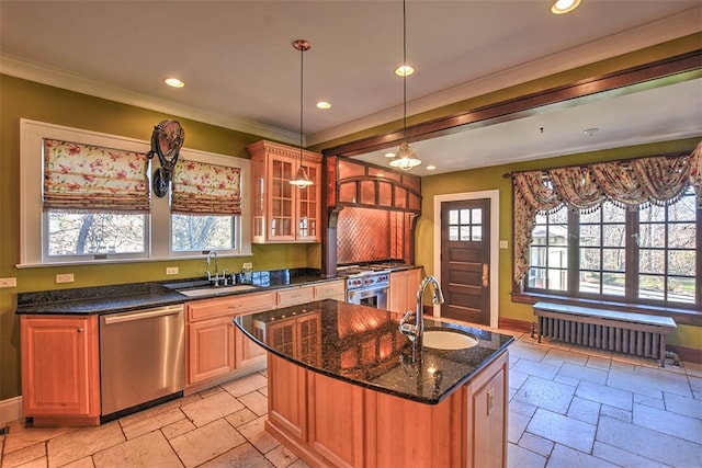 kitchen featuring radiator heating unit, stainless steel appliances, a center island with sink, and sink