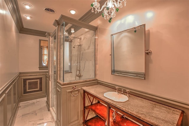 bathroom featuring vanity, a shower with door, and crown molding