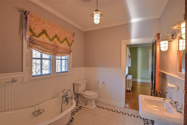 580 Powers Ln, Decatur, IL 62522 - full bath with radiator, wainscoting, a freestanding tub, toilet, and crown molding