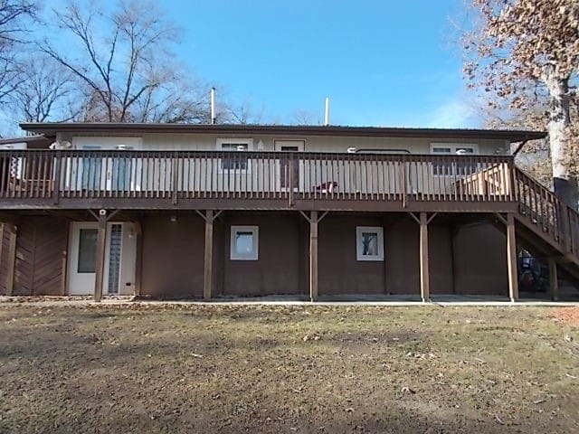 back of property featuring a wooden deck