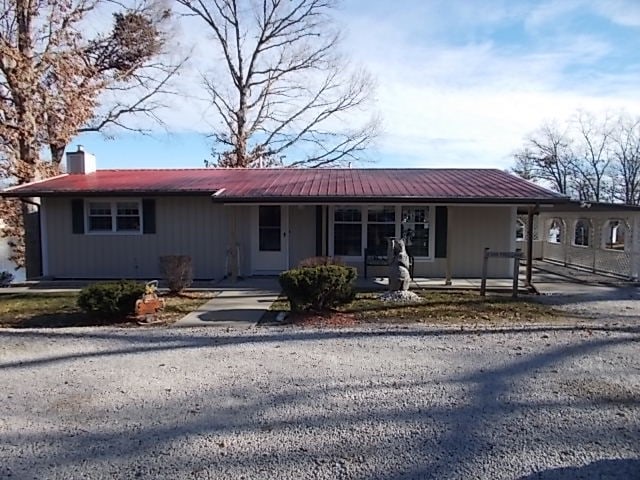 single story home featuring covered porch