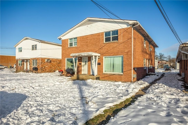 view of snow covered back of property