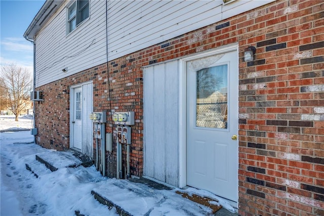 view of snow covered property entrance