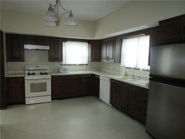 506 W 5th St, Pana, IL 62557 - kitchen featuring white appliances, under cabinet range hood, a sink, dark brown cabinetry, and light countertops