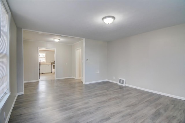 empty room with light hardwood / wood-style flooring